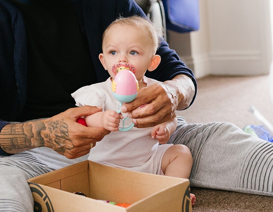 baby playing with rattle